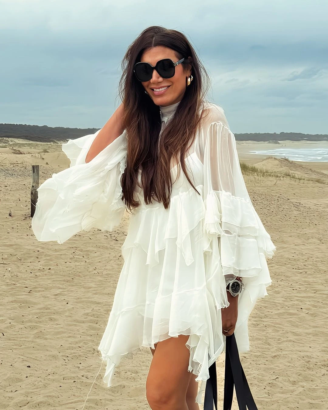 En su último viaje a a Punta del Este, Flor de la V apostó a un vestido blanco irregular para pasear por la playa. 